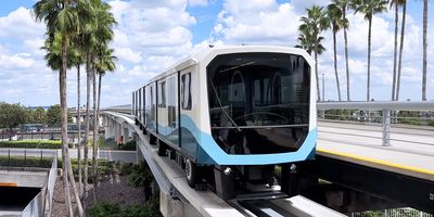 An MCO tram with the control tower in the background.